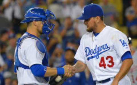 Aug 11, 2015; Los Angeles, CA, USA; Los Angeles Dodgers relief pitcher Luis Avilan (43) is met by catcher Yasmani Grandal (9) after a save in the ninth inning of the game against the Washington Nationals at Dodger Stadium. Dodgers won 5-0. Mandatory Credit: Jayne Kamin-Oncea-USA TODAY Sports