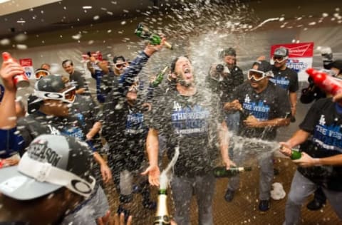 Sep 29, 2015; San Francisco, CA, USA; Los Angeles Dodgers teammates spray champagne on starting pitcher Clayton Kershaw (22) in the locker room after clinching the NL west after a win against the San Francisco Giants at AT&T Park.The Los Angeles Dodgers defeated the San Francisco Giants 8-0. Mandatory Credit: Kelley L Cox-USA TODAY Sports