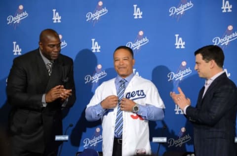 Dec 1, 2015; Los Angeles, CA, USA; Los Angeles Dodgers partner Magic Johnson (left) and president of baseball operations Andrew Friedman present Dave Roberts with Dodgers jersey at the press conference to announce Roberts as the first minority manager in Dodgers franchise history at Dodger Stadium. Mandatory Credit: Kirby Lee-USA TODAY Sports