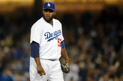 April 28, 2016; Los Angeles, CA, USA; Los Angeles Dodgers relief pitcher Pedro Baez (52) reacts after being called for a balk which results in a run scored by Miami Marlins second baseman Dee Gordon (9) in the seventh inning at Dodger Stadium. Mandatory Credit: Gary A. Vasquez-USA TODAY Sports