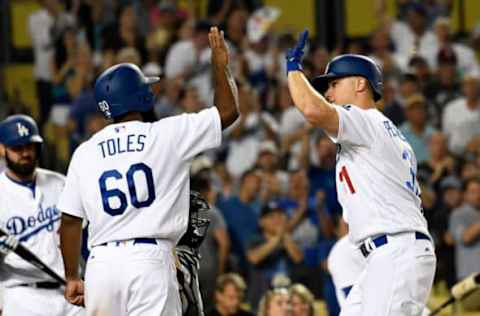 Jul 29, 2016; Los Angeles, CA, USA; Los Angeles Dodgers center fielder Joc Pederson (31) and center fielder Andrew Toles (60) celebrate scoring against the Arizona Diamondbacks during the seventh inning at Dodger Stadium. Mandatory Credit: Richard Mackson-USA TODAY Sports