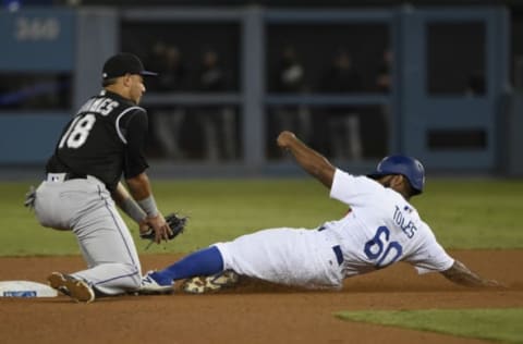 Sep 23, 2016; Los Angeles, CA, USA; Los Angeles Dodgers left fielder Andrew Toles (60) is tagged out by Colorado Rockies shortstop Cristhian Adames (18) while attempting to steal second during the eighth inning at Dodger Stadium. Mandatory Credit: Kelvin Kuo-USA TODAY Sports