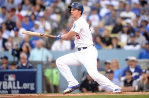 Oct 18, 2016; Los Angeles, CA, USA; Los Angeles Dodgers shortstop Corey Seager (5) hits a single during the first inning against the Chicago Cubs in game three of the 2016 NLCS playoff baseball series at Dodger Stadium. Mandatory Credit: Gary A. Vasquez-USA TODAY Sports