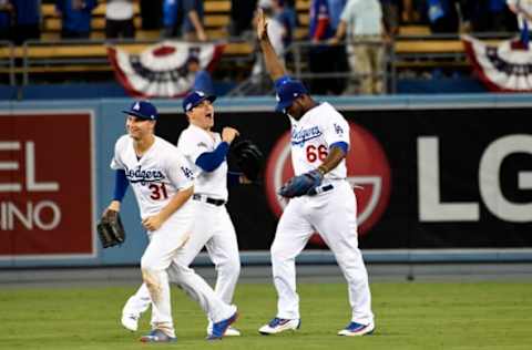 Oct 18, 2016; Los Angeles, CA, USA; Los Angeles Dodgers right fielder Yasiel Puig (66) celebrates with Los Angeles Dodgers center fielder Joc Pederson (31) after beating the Chicago Cubs in game three of the 2016 NLCS playoff baseball series at Dodger Stadium. Mandatory Credit: Richard Mackson-USA TODAY Sports