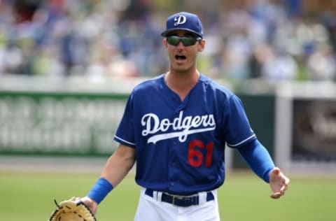 Mar 21, 2017; Phoenix, AZ, USA; Los Angeles Dodgers first baseman Cody Bellinger (61) hits a sacrifice fly against the Milwaukee Brewers during the fourth inning at Camelback Ranch. third Credit: Joe Camporeale-USA TODAY Sports