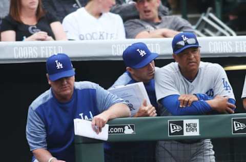 Apr 7, 2017; Denver, CO, USA; Los Angeles Dodgers manager Dave Roberts (right) watches from the dugout during the eight inning against the Colorado Rockies at Coors Field. The Rockies won 2-1. Mandatory Credit: Chris Humphreys-USA TODAY Sports