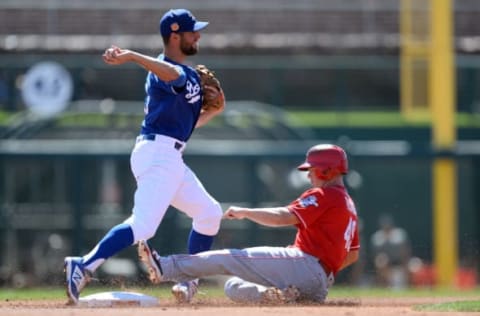 Mar 14, 2017; Phoenix, AZ, USA; Los Angeles Dodgers third baseman Chris Taylor (3) throws to first base to complete a double play after forcing out Cincinnati Reds second baseman Tony Renda (49) at second base during the first inning at Camelback Ranch. Mandatory Credit: Joe Camporeale-USA TODAY Sports