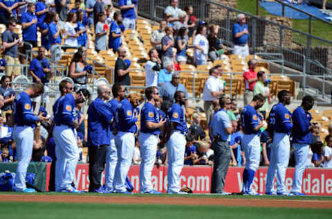 Mar 16, 2017; Phoenix, AZ, USA; Members of the Los Angeles Dodgers look on during the national anthem during a spring training game against the Chicago Cubs at Camelback Ranch. Mandatory Credit: Matt Kartozian-USA TODAY Sports