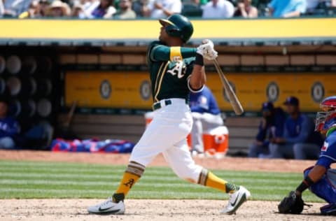 Apr 19, 2017; Oakland, CA, USA; Oakland Athletics left fielder Khris Davis (2) hits a home run against the Texas Rangers during the fifth inning at Oakland Coliseum. Mandatory Credit: Stan Szeto-USA TODAY Sports