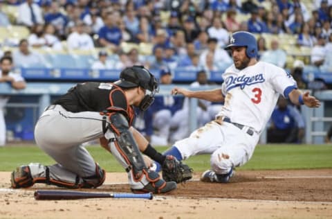 May 19, 2017; Los Angeles, CA, USA; Miami Marlins catcher J.T. Realmuto (left) tags out Los Angeles Dodgers second baseman Chris Taylor (3) at home during the first inning at Dodger Stadium. Mandatory Credit: Kelvin Kuo-USA TODAY Sports