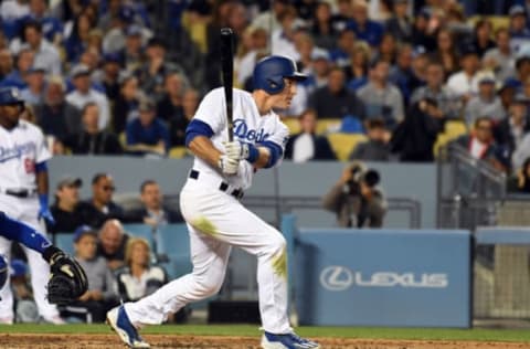 May 26, 2017; Los Angeles, CA, USA; Los Angeles Dodgers second baseman Chase Utley (26) hits a solo home run against the Chicago Cubs in the third inning at Dodger Stadium. Mandatory Credit: Richard Mackson-USA TODAY Sports