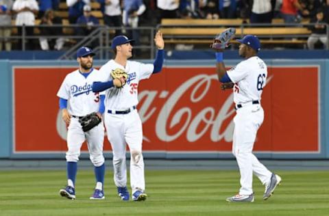 May 26, 2017; Los Angeles, CA, USA; Los Angeles Dodgers second baseman Chris Taylor (3) and left fielder Cody Bellinger (35) and right fielder Yasiel Puig (66) celebrate defeating the Chicago Cubs at Dodger Stadium. Mandatory Credit: Richard Mackson-USA TODAY Sports