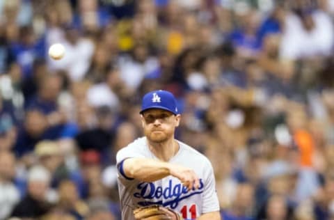 Jun 2, 2017; Milwaukee, WI, USA; Los Angeles Dodgers third baseman Logan Forsythe (11) throws to first base during the seventh inning against the Milwaukee Brewers at Miller Park. Mandatory Credit: Jeff Hanisch-USA TODAY Sports