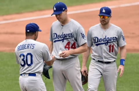 Jun 15, 2017; Cleveland, OH, USA; Los Angeles Dodgers third baseman Logan Forsythe (11) watches as manager Dave Roberts (30) takes the ball from starting pitcher Rich Hill (44) during a pitching change in the fifth inning against the Cleveland Indians at Progressive Field. Mandatory Credit: David Richard-USA TODAY Sports