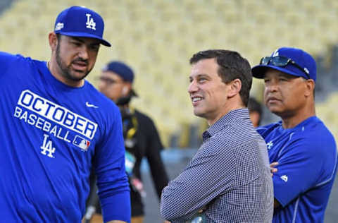 Oct 17, 2016; Los Angeles, CA, USA; Los Angeles Dodgers first baseman Adrian Gonzalez (23) talks with manager Dave Roberts (right) and Dodgers president of baseball operations Andrew Friedman (middle) during today’s batting practice and workout prior to game one of the NLCS against the Chicago Cubs at Dodger Stadium. Mandatory Credit: Jayne Kamin-Oncea-USA TODAY Sports