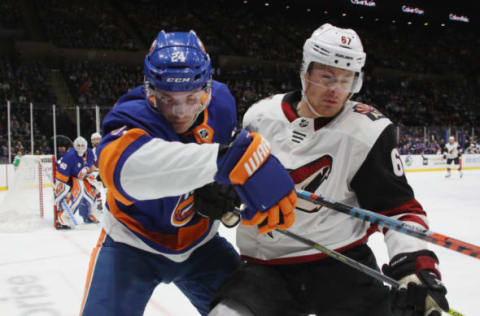 UNIONDALE, NEW YORK – MARCH 24: Lawson Crouse #67 of the Arizona Coyotes battles with Scott Mayfield #24 of the New York Islanders during the first period at NYCB Live’s Nassau Coliseum on March 24, 2019 in Uniondale, New York. The Islanders shut-out the Coyotes 2-0. (Photo by Bruce Bennett/Getty Images)