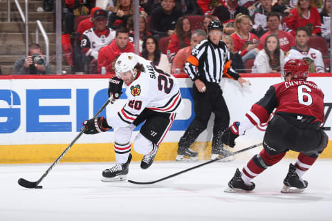 GLENDALE, ARIZONA – MARCH 26: Brandon Saad #20 of the Chicago Blackhawks skates with the puck past Jakob Chychrun #6 of the Arizona Coyotes during the second period of the NHL game at Gila River Arena on March 26, 2019 in Glendale, Arizona. (Photo by Christian Petersen/Getty Images)