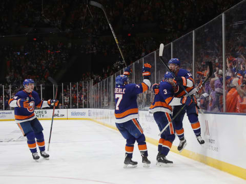 UNIONDALE, NEW YORK – APRIL 10: (l-r) Adam Pelech #3 and Josh Bailey #12 of the New York Islanders celebrate Bailey’s game winning overtime goal against the Pittsburgh Penguins in Game One of the Eastern Conference First Round during the 2019 NHL Stanley Cup Playoffs at NYCB Live’s Nassau Coliseum on April 10, 2019 in Uniondale, New York. The Islanders defeated the Penguins 4-3 in overtime. (Photo by Bruce Bennett/Getty Images)