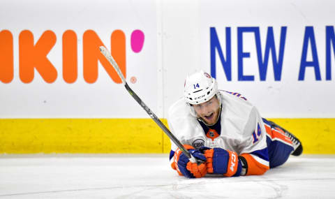 RALEIGH, NORTH CAROLINA – MAY 03: Tom Kuhnhackl #14 of the New York Islanders lays on the ice after being hit by a teammates stick against the Carolina Hurricanes in the third period of Game Four of the Eastern Conference Second Round during the 2019 NHL Stanley Cup Playoffs at PNC Arena on May 03, 2019 in Raleigh, North Carolina. The Hurricanes won 5-2 and won the series, 4-0. (Photo by Grant Halverson/Getty Images)