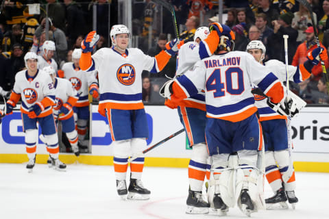 BOSTON, MASSACHUSETTS – DECEMBER 19: Ross Johnston #32 of the New York Islanders joins teammates to celebrate with Semyon Varlamov #40 after defeating the Boston Bruins in an overtime shootout at TD Garden on December 19, 2019 in Boston, Massachusetts. The Islanders defeat the Bruins 3-2. (Photo by Maddie Meyer/Getty Images)