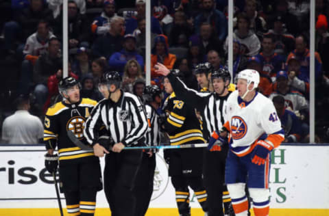 Brad Marchand #63 of the Boston Bruins holds the stick belonging to Leo Komarov #47 of the New York Islanders. (Photo by Bruce Bennett/Getty Images)