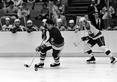 Clark Gillies #9 of the New York Islanders skates with the puck as center Bob McManama #15 of the Pittsburgh Penguins. (Photo by George Gojkovich/Getty Images)