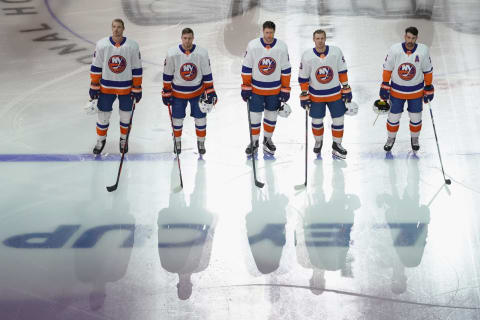 The New York Islanders stand at attention during the national anthems (Photo by Andre Ringuette/Freestyle Photo/Getty Images)