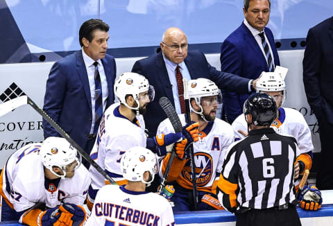 Head coach Barry Trotz of the New York Islanders speaks to referee Francis Charron #6 (Photo by Elsa/Getty Images)