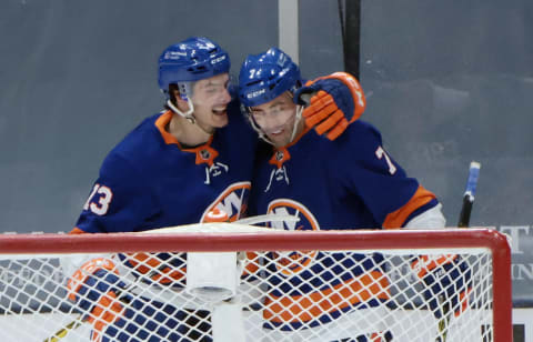 UNIONDALE, NEW YORK – FEBRUARY 25: Mathew Barzal #13 of the New York Islanders celebrates his first period goal against the Boston Bruins along with Jordan Eberle #7 at Nassau Coliseum on February 25, 2021 in Uniondale, New York. (Photo by Bruce Bennett/Getty Images)