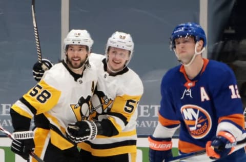 UNIONDALE, NEW YORK – FEBRUARY 27: Kris Letang #58 of the Pittsburgh Penguins celebrates his goal at 2:43 of the second period against the New York Islanders and is joined by Teddy Blueger #53 at the Nassau Coliseum on February 27, 2021 in Uniondale, New York. (Photo by Bruce Bennett/Getty Images)