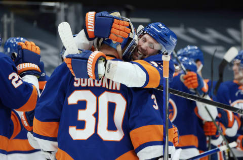 UNIONDALE, NEW YORK – MARCH 07: Casey Cizikas #53 and Ilya Sorokin #30 of the New York Islanders celebrate their 5-2 victory over the Buffalo Sabres at the Nassau Coliseum on March 07, 2021 in Uniondale, New York. (Photo by Bruce Bennett/Getty Images)