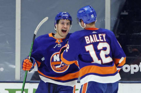 Mathew Barzal #13 of the New York Islanders is joined by Josh Bailey #12. (Photo by Bruce Bennett/Getty Images)