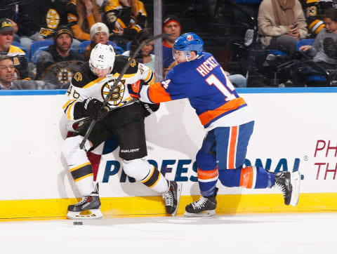 UNIONDALE, NY – JANUARY 29: David Krejci #46 of the Boston Bruins and Thomas Hickey #14 of the New York Islanders battle for the puck during their game at the Nassau Veterans Memorial Coliseum on January 29, 2015 in Uniondale, New York. (Photo by Al Bello/Getty Images)