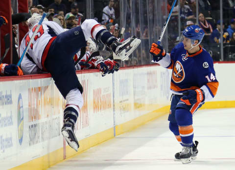 NEW YORK, NY – JANUARY 07: Thomas Hickey #14 of the New York Islanders checks Tom Wilson #43 of the Washington Capitals during the first period at the Barclays Center on January 7, 2016 in the Brooklyn borough of New York City. (Photo by Bruce Bennett/Getty Images)