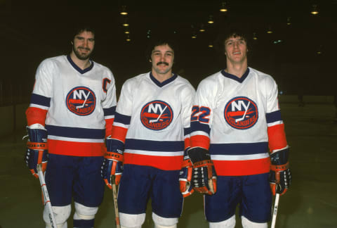 UNIONDALE – 1979: From left, Canadian ice hockey players Clark Gillies, Bryan Trottier, and Mike Bossy of the New York Islanders pose together on the ice in March of 1979 in Uniondale, New York. (Photo by Bruce Bennett Studios via Getty Images Studios/Getty Images)