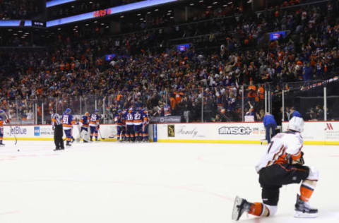 NEW YORK, NY – OCTOBER 16: Josh Bailey #12 and the New York Islanders celebrate his game winning overtime goal at 54 seconds against the Anaheim Ducks as Andrew Cogliano #7 watches the celebration at the Barclays Center on October 16, 2016 in the Brooklyn borough of New York City. The Islanders defeated the Ducks 3-2 in overtime. (Photo by Bruce Bennett/Getty Images)