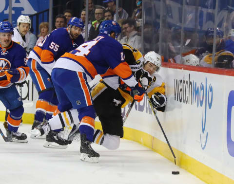 NEW YORK, NY – NOVEMBER 18: Thomas Hickey #14 of the New York Islanders hits Chris Kunitz #14 of the Pittsburgh Penguins into the boards during the first period at the Barclays Center on November 18, 2016 in the Brooklyn borough of New York City. (Photo by Bruce Bennett/Getty Images)