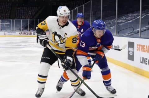 UNIONDALE, NEW YORK – FEBRUARY 06: Sidney Crosby #87 of the Pittsburgh Penguins skates against Mathew Barzal #13 of the New York Islanders at the Nassau Coliseum on February 06, 2021 in Uniondale, New York. (Photo by Bruce Bennett/Getty Images)