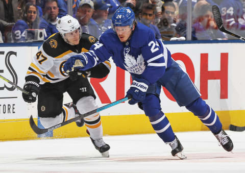 TORONTO, ON – APRIL 17: Torey Krug #47 of the Boston Bruins tries to hold up Kasperi Kapanen #24 of the Toronto Maple Leafs in Game Four of the Eastern Conference First Round during the 2019 NHL Stanley Cup Playoffs at Scotiabank Arena on April 17, 2019 in Toronto, Ontario, Canada. The Bruins defeated the Maple Leafs 6-4. (Photo by Claus Andersen/Getty Images)