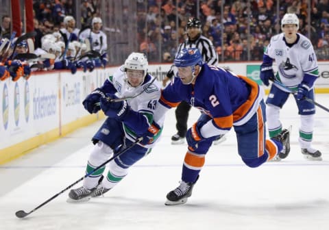 NEW YORK, NEW YORK – FEBRUARY 01: Quinn Hughes #43 of the Vancouver Canucks goes up against Nick Leddy #2 of the New York Islanders at the Barclays Center on February 01, 2020 in the Brooklyn borough of New York City. (Photo by Bruce Bennett/Getty Images)