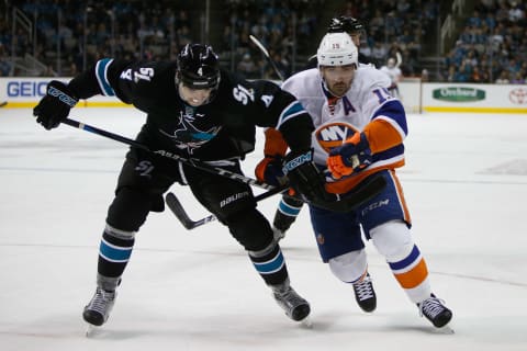 Nov 25, 2016; San Jose, CA, USA; San Jose Sharks defenseman Brenden Dillon (4) and New York Islanders right wing Cal Clutterbuck (15) race towards the puck in the third period of the game at SAP Center at San Jose. The San Jose Sharks defeated the New York Islanders with a score of 3-2. Mandatory Credit: Stan Szeto-USA TODAY Sports