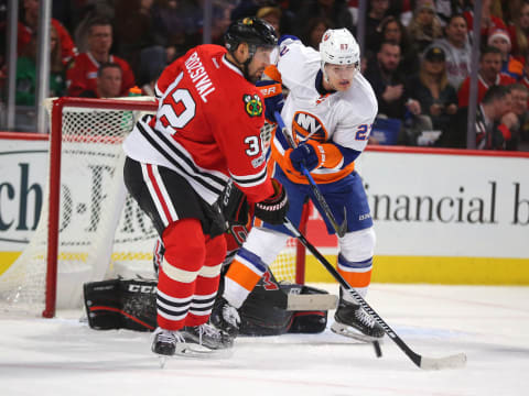 Mar 3, 2017; Chicago, IL, USA; New York Islanders left wing Anders Lee (27) tries to tip a shot against Chicago Blackhawks defenseman Michal Rozsival (32) in front of goalie Corey Crawford (50) during the second period at the United Center. Chicago won 2-1 in s shoot out. Mandatory Credit: Dennis Wierzbicki-USA TODAY Sports