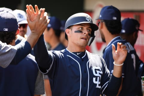 GOODYEAR, ARIZONA – MARCH 18: Luis Urias #9 of the San Diego Padres celebrates with teammates in the dugout after scoring a run against the Cleveland Indians during the first inning of a spring training game at Goodyear Ballpark on March 18, 2019 in Goodyear, Arizona. Urias scored on a double by teammate Franmil Reyes #32. (Photo by Norm Hall/Getty Images)