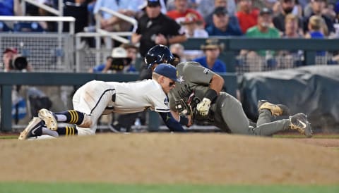 Blake Nelson #10 of the Michigan Wolverines tags out Austin Martin #16 of the Vanderbilt Commodores San Diego Padres MLB Draft targets. (Photo by Peter Aiken/Getty Images)