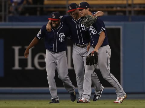 LOS ANGELES, CALIFORNIA – JULY 06: (L-R) Manuel  Margot #7, Hunter  Renfroe #10 and Wil  Myers #4 of the San Diego Padres celebrate in the outfield after the MLB game against the Los Angeles Dodgers at Dodger Stadium on July 06, 2019 in Los Angeles, California. The Padres defeated the Dodgers 3-1. (Photo by Victor Decolongon/Getty Images)