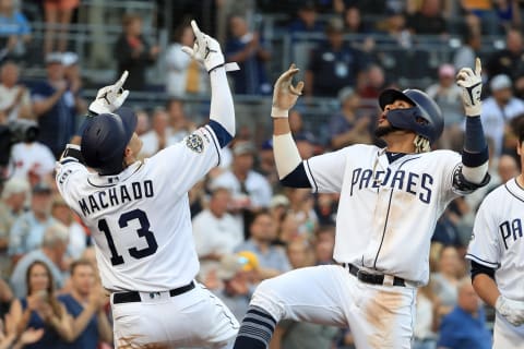 Manny Machado #13 congratulates Fernando Tatis Jr. #23. (Photo by Sean M. Haffey/Getty Images)