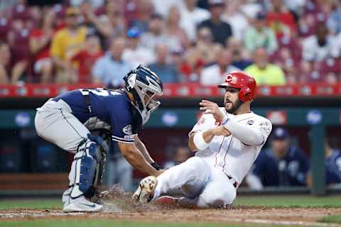 Eugenio  Suarez #7 of the Cincinnati Reds is tagged out by Francisco  Mejia #27 of the San Diego Padres. (Photo by Joe Robbins/Getty Images)