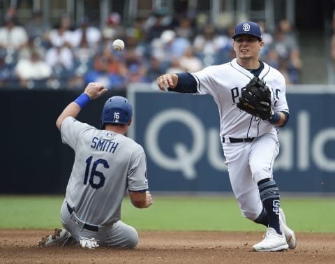 SAN DIEGO, CA – SEPTEMBER 26: Luis  Urias #9 of the San Diego Padres throws over Will Smith #16 of the Los Angeles Dodgers as he tries to turn a double play during the the fifth inning of a baseball game at Petco Park September 26, 2019 in San Diego, California. (Photo by Denis Poroy/Getty Images)