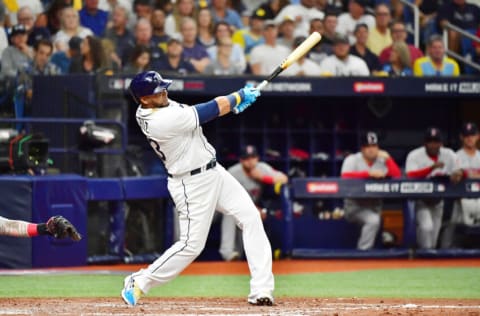 ST PETERSBURG, FLORIDA - OCTOBER 07: Nelson Cruz #23 of the Tampa Bay Rays hits a solo homerun in the third inning against the Boston Red Sox during Game 1 of the American League Division Series at Tropicana Field on October 07, 2021 in St Petersburg, Florida. (Photo by Julio Aguilar/Getty Images)