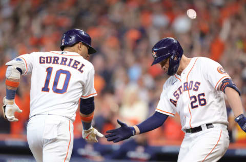 HOUSTON, TEXAS - OCTOBER 11: Yuli Gurriel #10 of the Houston Astros celebrates his solo home run against the Seattle Mariners with Trey Mancini #26 during the fourth inning in game one of the American League Division Series at Minute Maid Park on October 11, 2022 in Houston, Texas. (Photo by Carmen Mandato/Getty Images)